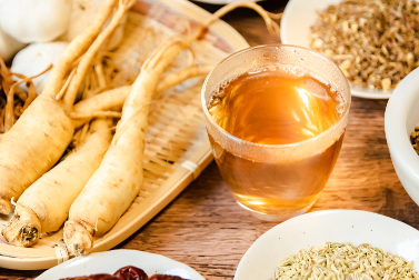 Ginseng root and ginseng tea on a wooden tabletop