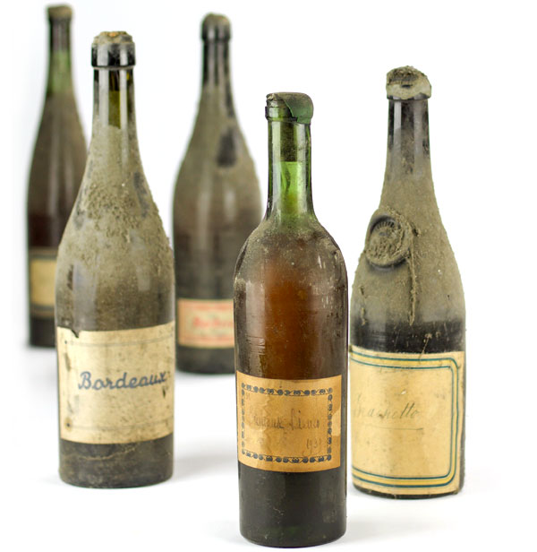 Dusty Old Green Bottles of Alcohol